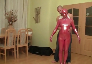 Aesthetic chick in a red latex suit demonstrates her love